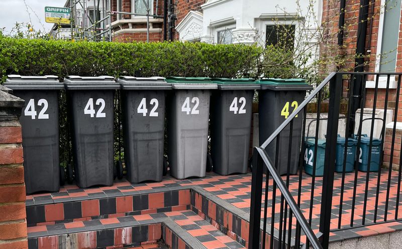 Six wheelie bins and three food waste bins, neatly ordered, bearing the number 42
