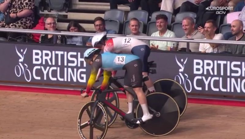 screen grab of Eurosport footage of two cyclist doing a trackstand. The author can be seen filming it on his phone.