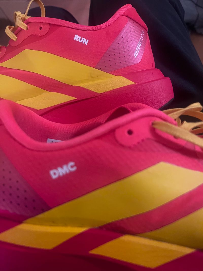 neon adidas Evo Sl trainers with RUN and DMC printed on the sides